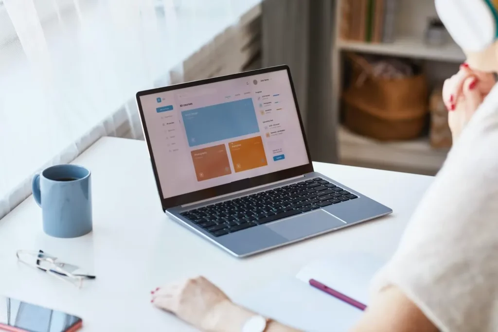 Woman viewing an online course dashboard on her laptop.